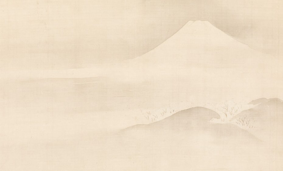 Misty mountain landscape with a distant peak.