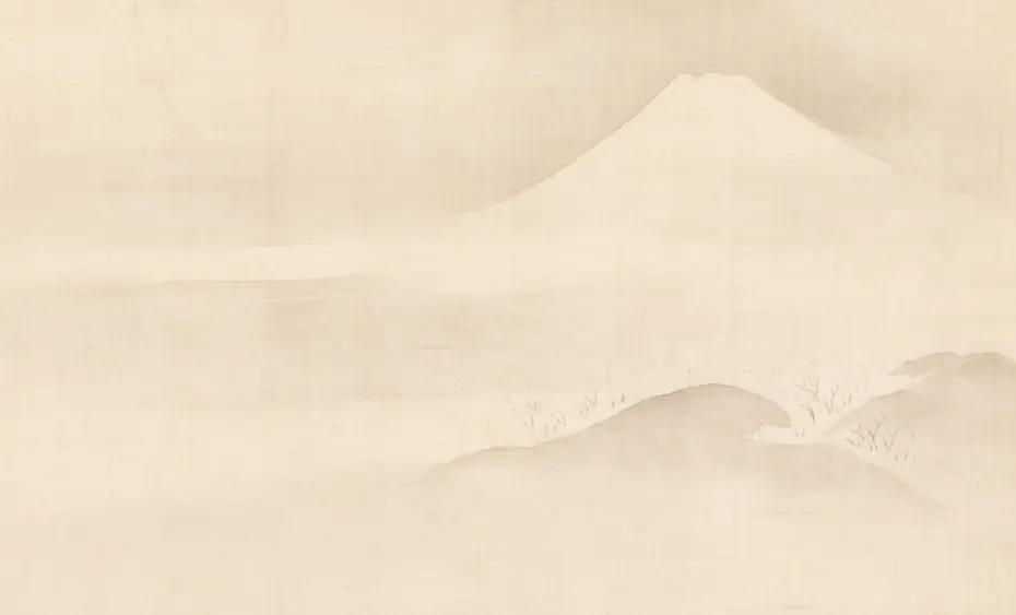 Misty mountain landscape with a distant peak.